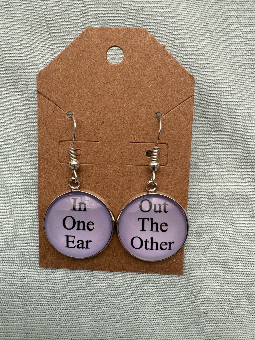 Novelty Lavender Phrase Dangle Earrings - "In One Ear / Out The Other"